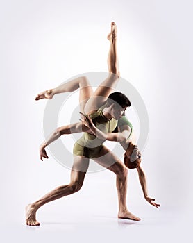 Couple of gymnasts posing on a light background