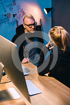 couple of hackers talking to each other at workplace