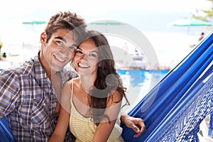 Couple, hammock and beach on holiday with smile for love, travel and vacation for honeymoon in Mauritius. Portrait