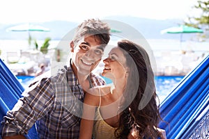 Couple, hammock relax at holiday resort for summer vacation in Hawaii for honeymoon, bonding or love. Man, woman and