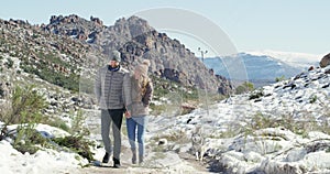 Couple, hand holding and snow in winter, dogs and terrain on honeymoon, love and holiday. Vacation, mountain and romance