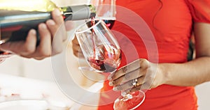 Couple, hands and bottle of red wine for celebration of love, romance and valentines day on their anniversary. People or