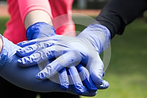 Couple of hands in the latex medical gloves.