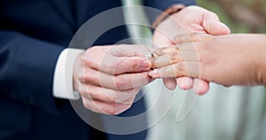 Couple, hands and ring for marriage, commitment or wedding in ceremony, love or support together. Closeup of people