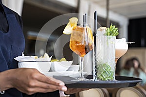 Couple hands toasting spritz and mojito - Young friends having fun together drinking cocktails at happy hour - First dating time