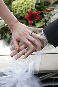 Couple hands with wedding ring before wedding car