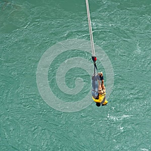 Couple hanging on a rope after a bungy jump at Kawarau Bridge