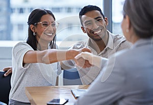 Couple, happy and handshake with financial consultant for deal, agreement or contract. Smile, man and woman shaking