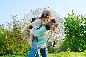 Couple of happy having fun teenagers together outdoor