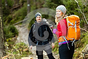 Couple happy hikers walking in mountains