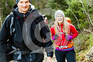 Couple happy hikers walking in mountains