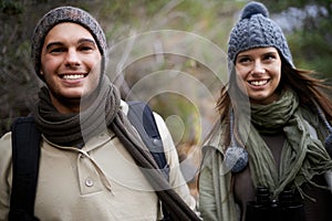 Couple, happy and hiking in forest or nature for travel, adventure or holiday for experience or fitness. Man, woman and