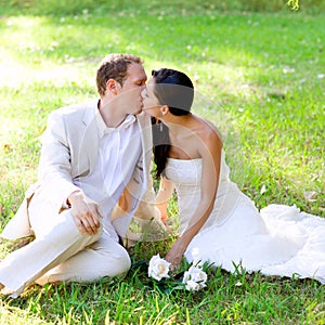 Couple happy in love kissing sitting in park