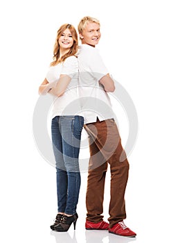 Couple of happy teenages posing together on white