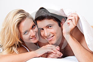 Couple has fun in bed. Laughter, joy and eroticism