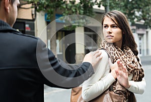 Couple having argue on city street in autumn day