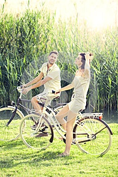 Couple having a bicycles ride into the nature