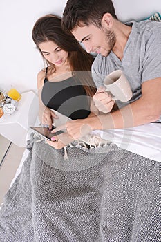 Couple having breakfast in bed.