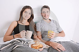 Couple having breakfast in bed.