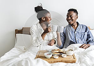 A couple having breakfast in bed