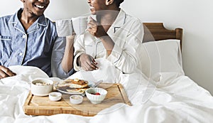 A couple having breakfast in bed