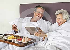 Couple having breakfast in bed