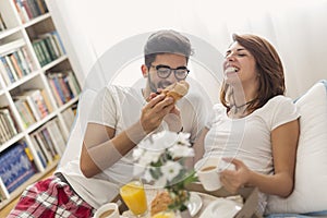 Couple having breakfast in bed