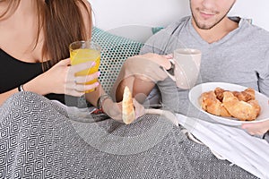 Couple having breakfast in bed.