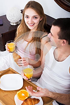 Couple having breakfast in bed