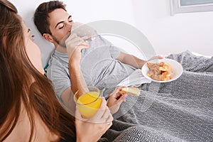 Couple having breakfast in bed.