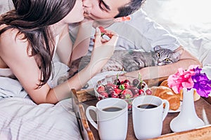 Couple having breakfast in bed