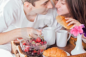 Couple having breakfast in bed