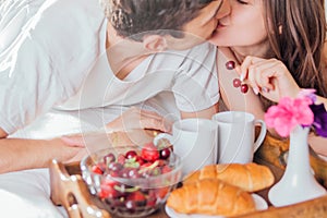Couple having breakfast in bed