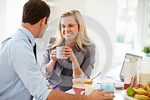 Couple Having Breakfast Together Before Leaving For Work