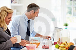 Couple Having Breakfast Together Before Leaving For Work
