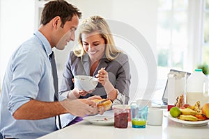 Couple Having Breakfast Together Before Leaving For Work