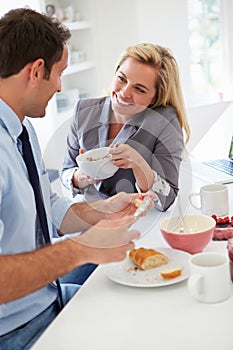 Couple Having Breakfast Together Before Leaving For Work