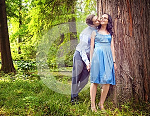 Couple having a candid romantic kiss outdoor photo