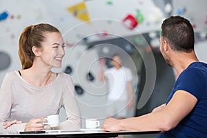 couple having coffee in wall climbing center