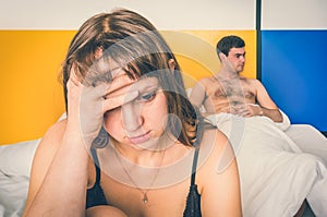 Couple having conflict in bed at home - family quarrel concept