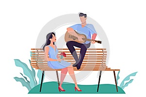 A couple having a date in the park, man playing guitar for woman.