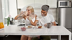 Couple having delicious breakfast at home kitchen