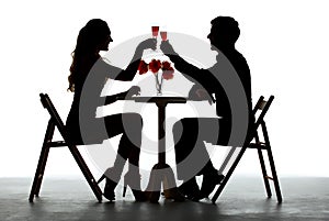 Couple Having Dinner With Wine Glass On Table