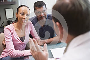 Couple having discussion with doctor in IVF clinic