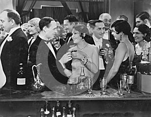 Couple having drink at crowded bar photo