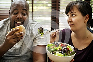 Couple having fast food on the couch photo