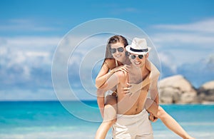 Couple having fun on the beach of a tropical ocean.