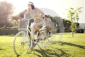 Couple having fun by bike on holiday to the lake