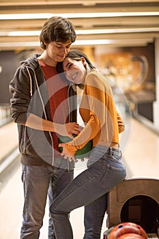 Couple having fun in bowling alley. Couple in hug