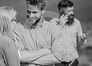 Couple having fun while busy businessman speak on phone. Couple flirting while man busy with mobile conversation